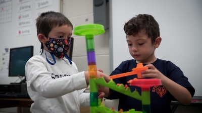 students are playing with a toy