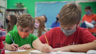 two students are writing