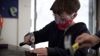 student uses hammer