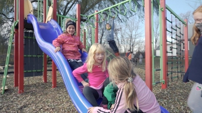 students on a slide in playground