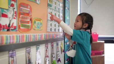 student shows a picture on the board