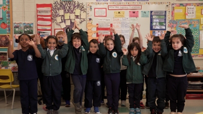 students waving hands